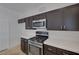 This kitchen includes stainless steel appliances, tile backsplash, and plenty of counter space at 829 Dancing Vines Ave, Las Vegas, NV 89183