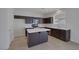 Modern kitchen with dark cabinets, stainless steel appliances, and a center island at 829 Dancing Vines Ave, Las Vegas, NV 89183