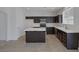 Modern kitchen with dark cabinets, stainless steel appliances, and a center island at 829 Dancing Vines Ave, Las Vegas, NV 89183
