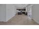 Open concept floor plan with a view of the kitchen and sliding doors with neutral colored floors at 829 Dancing Vines Ave, Las Vegas, NV 89183