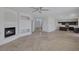 Open floor plan with fireplace, adjacent kitchen with center island, and neutral tile flooring at 829 Dancing Vines Ave, Las Vegas, NV 89183
