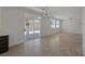 Bright and airy living room with sliding glass doors leading to the backyard and tile flooring at 829 Dancing Vines Ave, Las Vegas, NV 89183