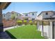 A lush backyard featuring artificial grass and privacy wall; perfect for outdoor entertaining at 871 Aurelie Ridge St, Henderson, NV 89011