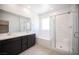 Modern bathroom with double vanity, soaking tub, and glass-enclosed shower at 871 Aurelie Ridge St, Henderson, NV 89011