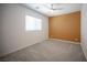 Cozy bedroom with a neutral color scheme, large window, and bright ceiling fan at 871 Aurelie Ridge St, Henderson, NV 89011