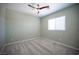 Serene bedroom featuring plush carpet, large window, and a modern ceiling fan at 871 Aurelie Ridge St, Henderson, NV 89011