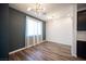 Bright dining room with modern chandelier lighting and dark accent wall at 871 Aurelie Ridge St, Henderson, NV 89011