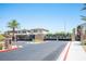 Gated entrance to a residential community with palm trees and manicured landscaping at 871 Aurelie Ridge St, Henderson, NV 89011