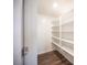 Pantry closet with white shelves and wood-look floors at 871 Aurelie Ridge St, Henderson, NV 89011