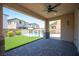 Covered patio offers a shady spot with a ceiling fan overlooking a backyard pool and artificial grass at 871 Aurelie Ridge St, Henderson, NV 89011