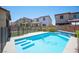 Backyard shot of a sparkling blue swimming pool with tanning ledge in a new residential neighborhood at 871 Aurelie Ridge St, Henderson, NV 89011