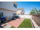 Backyard view featuring wooden deck, artificial turf, patio furniture, and partial view of the house at 9322 Straw Hays St # 103, Las Vegas, NV 89178