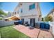 A view of a backyard with a wooden deck, artificial turf, a BBQ, and patio furniture at 9322 Straw Hays St # 103, Las Vegas, NV 89178