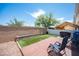 Charming backyard features a wooden deck, artificial turf, and a stone planter against the brick wall at 9322 Straw Hays St # 103, Las Vegas, NV 89178