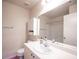 Clean bathroom featuring white vanity, medicine cabinet, toilet, and mirrored wall at 9322 Straw Hays St # 103, Las Vegas, NV 89178