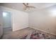 Bedroom with hard surface floors, ceiling fan, and natural light at 9322 Straw Hays St # 103, Las Vegas, NV 89178