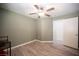 Cozy bedroom featuring wood-look flooring, ceiling fan, closet and view of ensuite bathroom at 9322 Straw Hays St # 103, Las Vegas, NV 89178