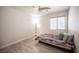 Cozy bedroom with wood-look floors and a ceiling fan at 9322 Straw Hays St # 103, Las Vegas, NV 89178