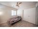Cozy bedroom with wood-look floors, a ceiling fan, and a double door closet at 9322 Straw Hays St # 103, Las Vegas, NV 89178