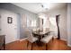 Bright dining room with wood floors, modern chandelier, and neutral decor at 9322 Straw Hays St # 103, Las Vegas, NV 89178