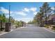 Community entrance with a gated entry, mature trees, and well-maintained landscaping at 9322 Straw Hays St # 103, Las Vegas, NV 89178