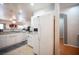 Bright kitchen with white cabinets, modern appliances, and view to living area at 9322 Straw Hays St # 103, Las Vegas, NV 89178