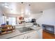Kitchen view showcasing white cabinetry, countertops, sink, and connection to the living area at 9322 Straw Hays St # 103, Las Vegas, NV 89178