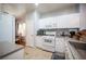 Well-equipped kitchen with white cabinetry, modern appliances, and tile flooring at 9322 Straw Hays St # 103, Las Vegas, NV 89178
