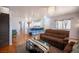 Open-concept living room flowing into a modern kitchen, with hardwood floors at 9322 Straw Hays St # 103, Las Vegas, NV 89178