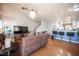 Comfortable living room with modern lighting, wood floors, and views to the breakfast bar at 9322 Straw Hays St # 103, Las Vegas, NV 89178
