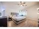 Main bedroom showcasing a bed, wood-look floors, ceiling fan, and natural lighting at 9322 Straw Hays St # 103, Las Vegas, NV 89178