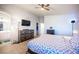 Main bedroom featuring a bed, wood-look floors, ceiling fan, natural light, and ensuite bathroom access at 9322 Straw Hays St # 103, Las Vegas, NV 89178