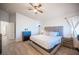 Main bedroom showcasing a bed, wood-look floors, ceiling fan, and natural lighting at 9322 Straw Hays St # 103, Las Vegas, NV 89178