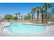 Community pool with palm trees, lounge chairs, and clear blue water for relaxation and recreation at 9322 Straw Hays St # 103, Las Vegas, NV 89178