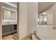 Modern bathroom with sleek vanity, and a decorative mirror at 9921 Mirada Dr, Las Vegas, NV 89144