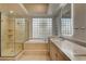 Luxurious bathroom featuring a glass-enclosed shower, soaking tub, and double vanity at 9921 Mirada Dr, Las Vegas, NV 89144
