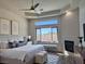 Brightly lit bedroom with a fireplace, modern decor, and a large window for natural light at 9921 Mirada Dr, Las Vegas, NV 89144