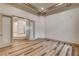 Bedroom featuring wood floors, tray ceiling and doors to an adjoined sitting area at 9921 Mirada Dr, Las Vegas, NV 89144