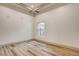 Bedroom featuring wood floors and a tray ceiling at 9921 Mirada Dr, Las Vegas, NV 89144
