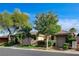 Inviting single-story home featuring a tile roof, a two-car garage, and mature trees in a landscaped front yard at 9921 Mirada Dr, Las Vegas, NV 89144