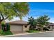 Attractive single-story home with a tile roof, two-car garage, and mature trees, showcasing curb appeal at 9921 Mirada Dr, Las Vegas, NV 89144