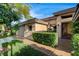 Inviting front entrance with a security gate, manicured hedges, and a well-maintained walkway at 9921 Mirada Dr, Las Vegas, NV 89144