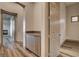 Hallway featuring wood flooring, a built-in cabinet, and doorways to other rooms at 9921 Mirada Dr, Las Vegas, NV 89144