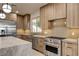 Modern kitchen features custom wood cabinets and stainless steel appliances at 9921 Mirada Dr, Las Vegas, NV 89144