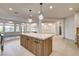 Bright open kitchen featuring a large center island, stainless steel appliances, and natural light at 9921 Mirada Dr, Las Vegas, NV 89144