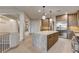 Kitchen featuring stainless steel appliances, center island with stone countertop and pendant lighting at 9921 Mirada Dr, Las Vegas, NV 89144