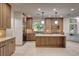 Gorgeous kitchen featuring wood cabinetry, stainless steel appliances, and a large island at 9921 Mirada Dr, Las Vegas, NV 89144