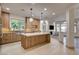 Modern kitchen featuring an island, light wood cabinets, stainless steel appliances, and contemporary lighting at 9921 Mirada Dr, Las Vegas, NV 89144