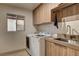 Well-organized laundry room with modern washer and dryer at 9921 Mirada Dr, Las Vegas, NV 89144