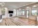 Bright and airy living room featuring a modern fireplace and large windows at 9921 Mirada Dr, Las Vegas, NV 89144